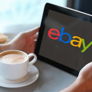 Man holding tablet computer in cafe