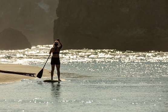 Junge Frau auf einem stand up paddle board