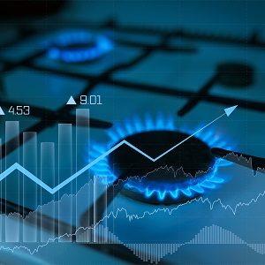 Gas flame from the gas burner with the natural gas price chart tending upwards