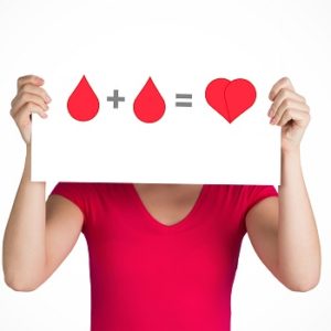 A blood donation sign being held up