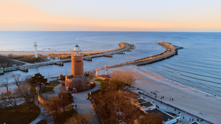 Leuchtturm, Hafenmole und Strand von Kolberg bei Sonnenuntergang